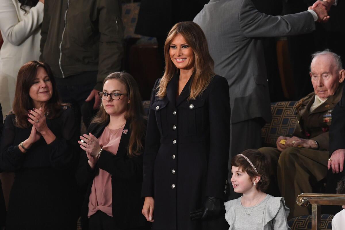 First lady Melania Trump, center, smiles as she arrives to attend the State of the Union address at the Capitol in Washington on Tuesday.