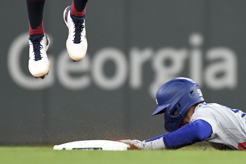 Atlanta, GA - October 17: Los Angeles Dodgers' Mookie Betts, right, dives to steal second base.