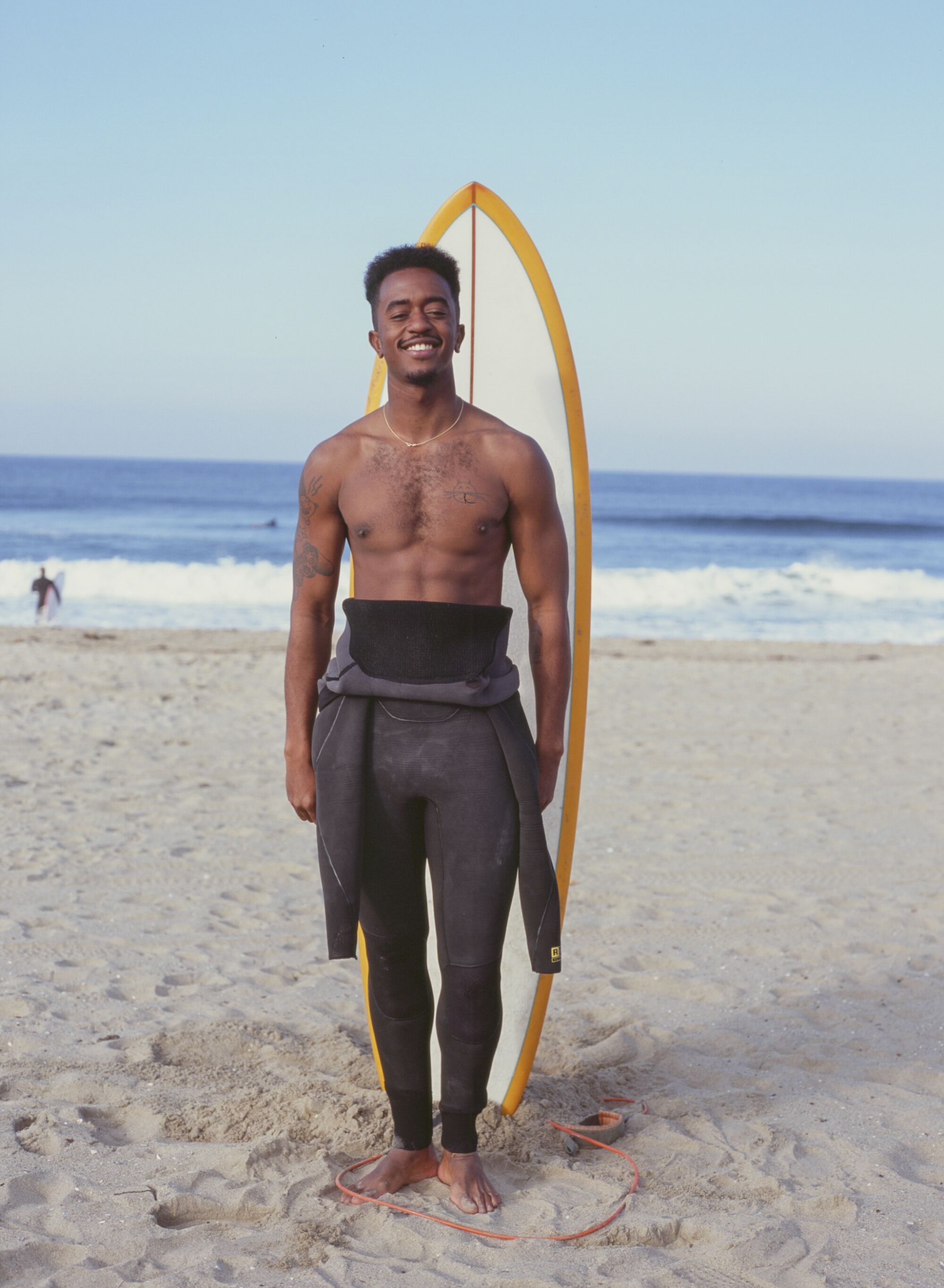 Brick Howze poses for a portrait before a morning surf session on Saturday, March 13, 2021.