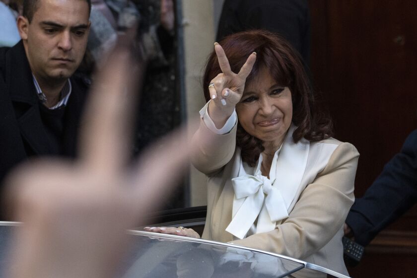 FILE - Argentine Vice President Cristina Fernandez greets supporters as she leaves her home in Buenos Aires, Argentina, Aug. 23, 2022. Federal court judges are preparing on Tuesday, Dec. 6, 2022, to announce their verdict in the corruption trial of Fernandez who is accused of running a criminal organization that fraudulently directed about $1 billion in public works projects to a construction magnate closely tied to her family. (AP Photo/Rodrigo Abd, File)
