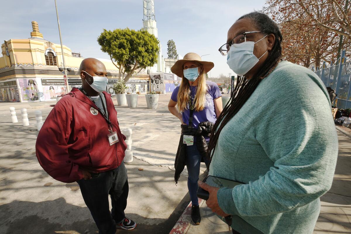 Anthony Ruffin, Sieglinde Von Deffner, Jeanette Rowe, talk as people arrive for Covid-19 shots at Leimart Park Plaza.
