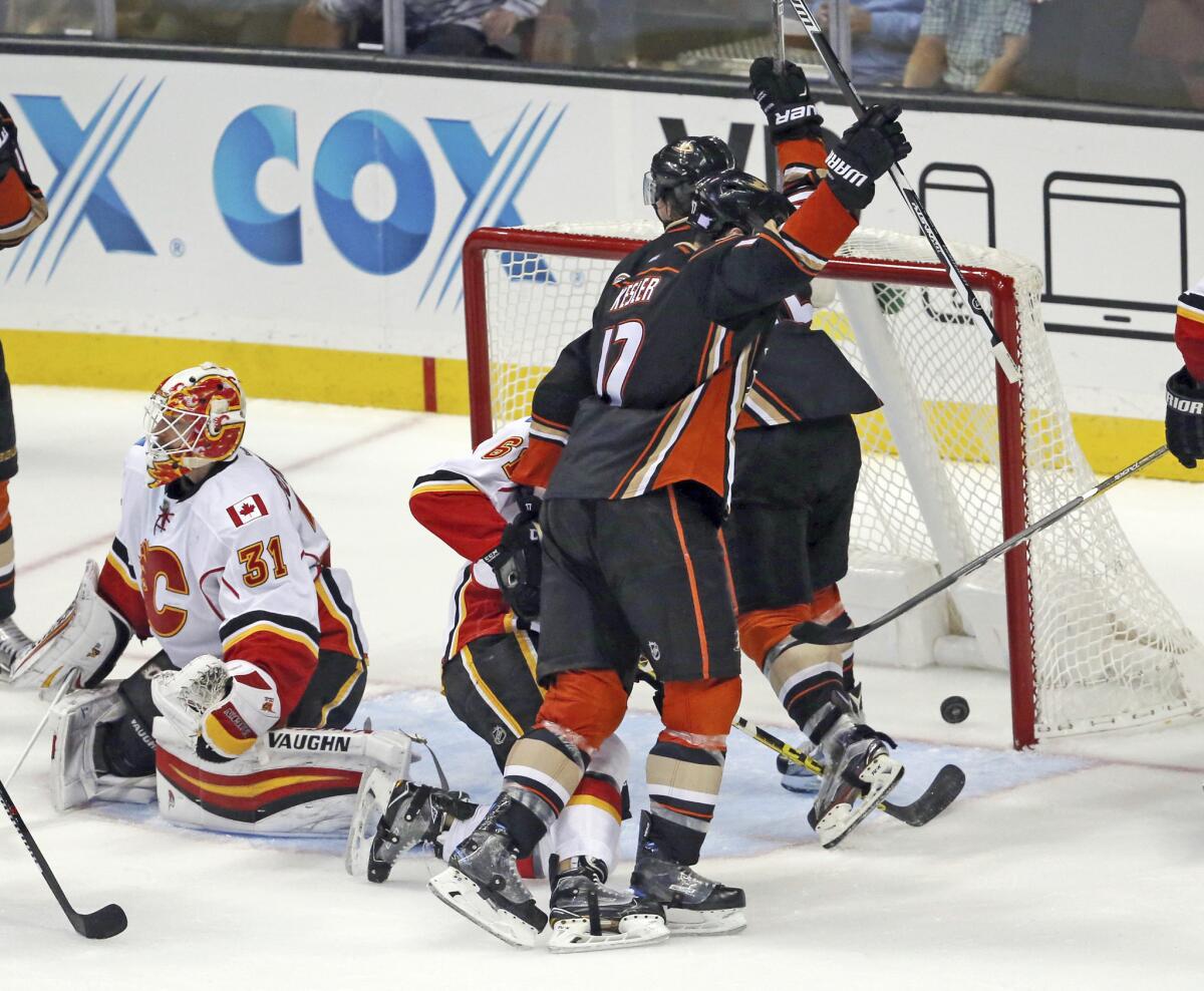 Ducks center Ryan Kesler (17) celebrates his goal as Calgary Flames goalie Chad Johnson (31) sits on the ice in the third period on Nov. 6.