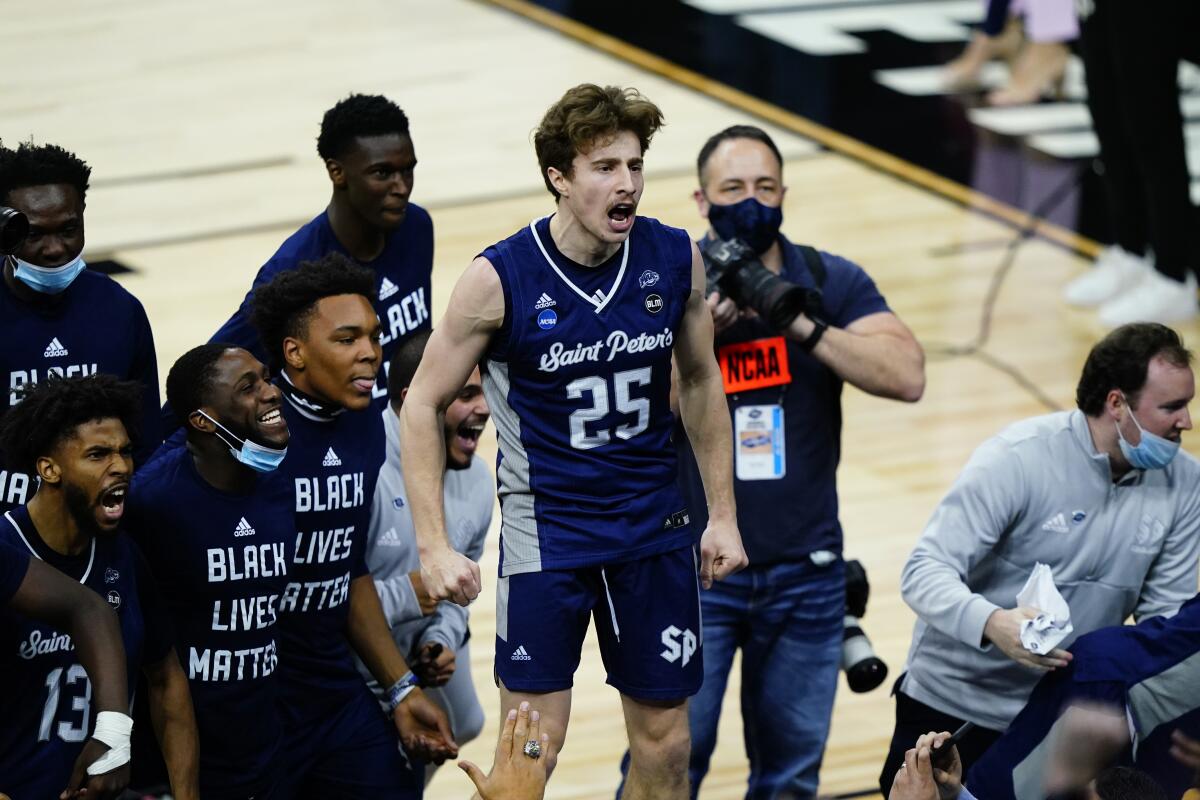 Saint Peter's Doug Edert (25) celebrates after beating Purdue in the Sweet 16 on Friday.
