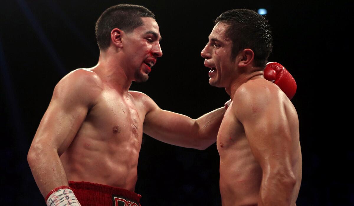 Unified Super Lightweight World Champion Danny "Swift" Garcia, left, and Mauricio “El Maestro” Herrera talk to each other after finishing their super lightweight boxing match at the Ruben Rodriguez Coliseum in Bayamon, Puerto Rico on March 15, 2014. Herrera will fight against Hank Lundy on Saturday in the last boxing match at the Los Angeles Sports Arena.