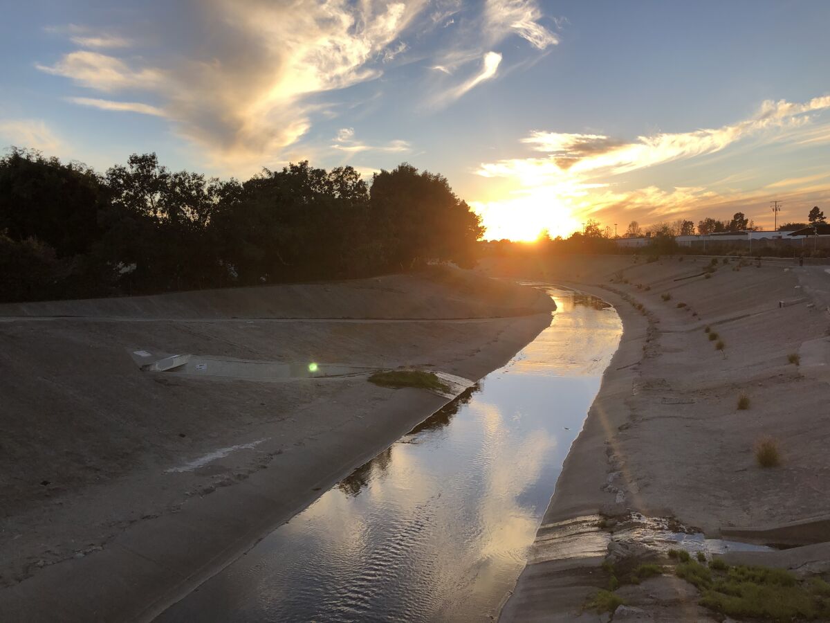 The sun sets over Ballona Creek on Dec. 25, 2020.