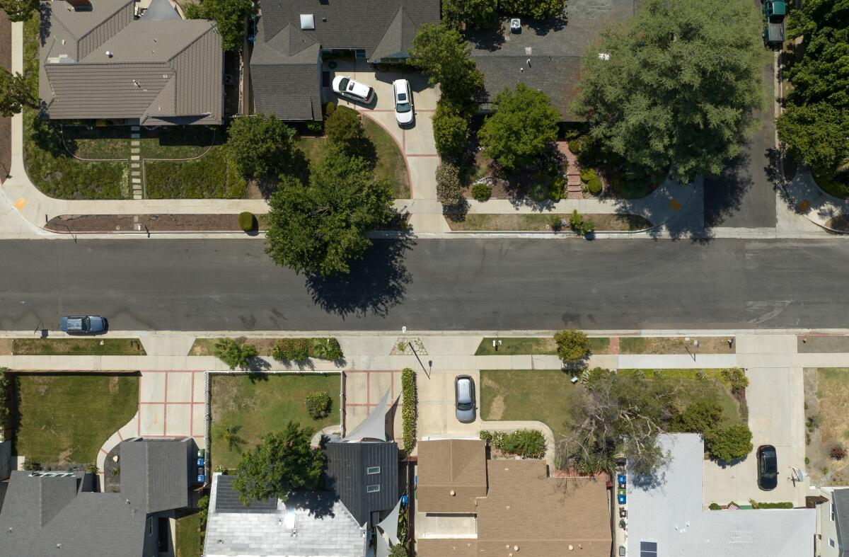 An aerial shot of houses with green lawns.