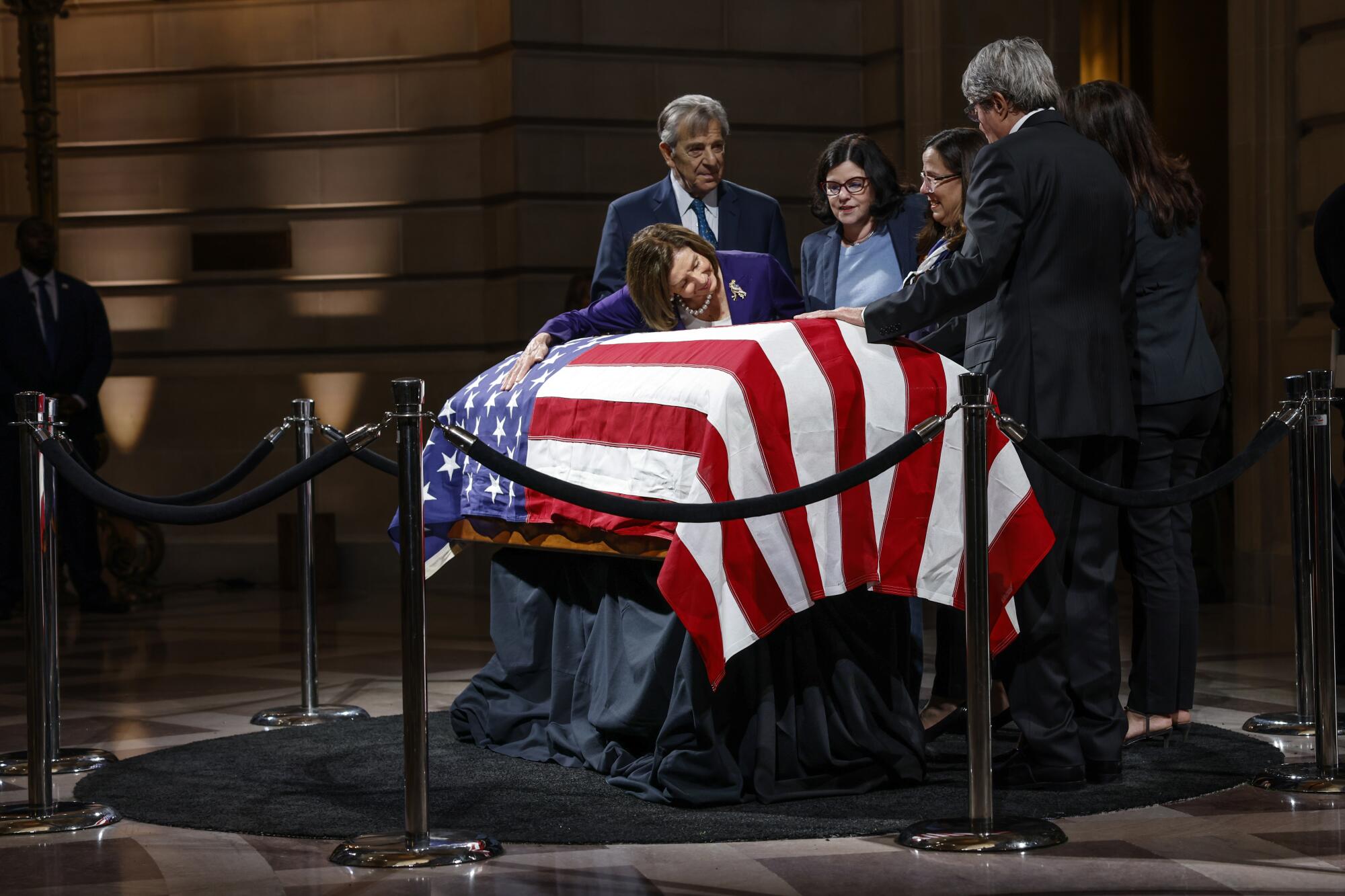 Rep Nancy Pelosi, left, pays her respects to Sen. Dianne Feinstein as she lies in state at San Francisco City Hall.