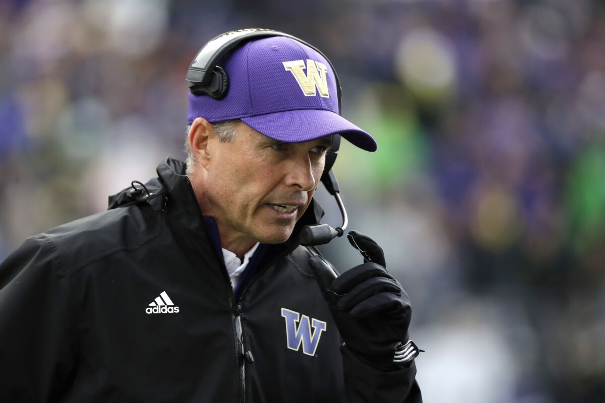 Then-Washington coach Chris Petersen walks on the field during a game against Oregon in 2019.