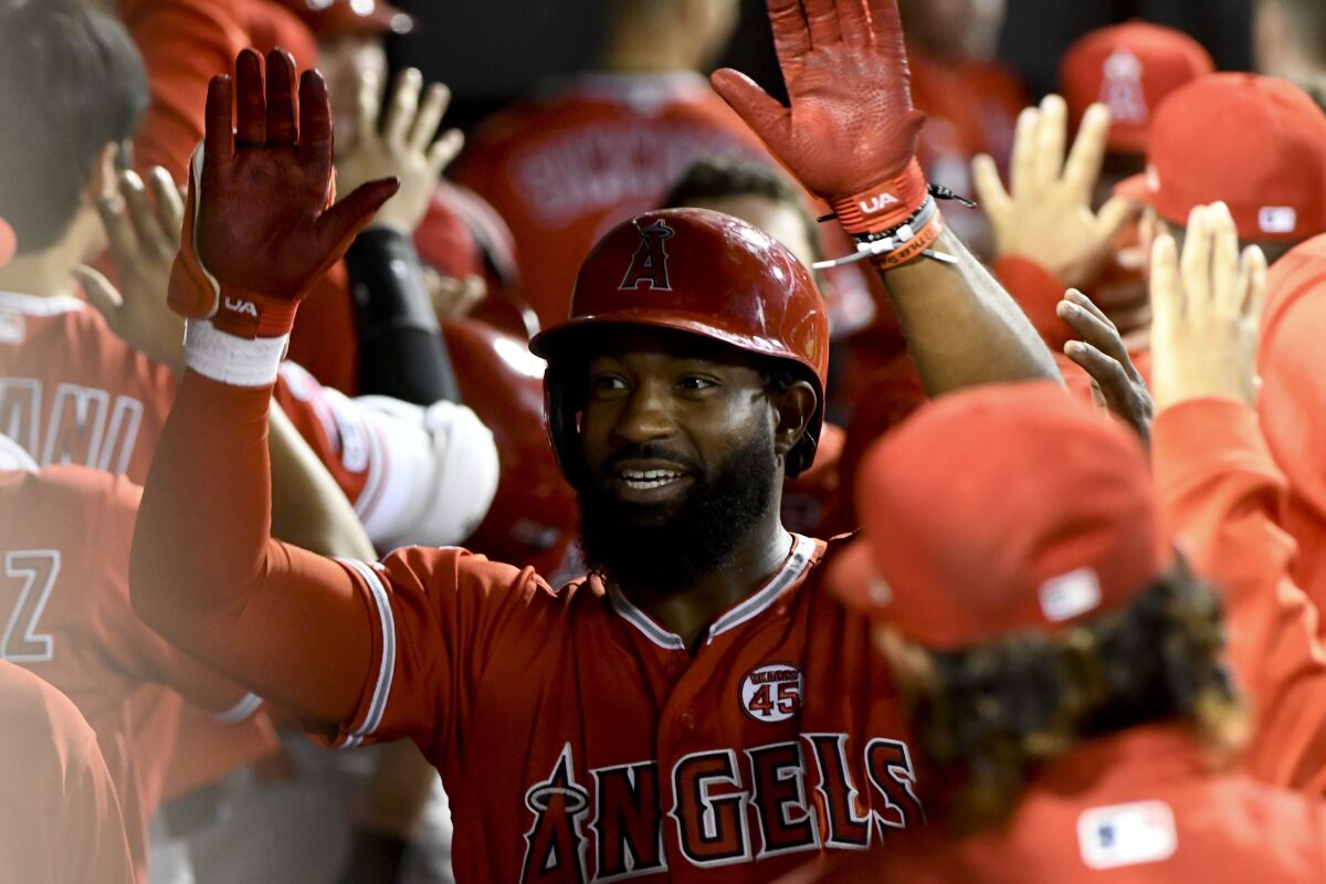 Brian Goodwin celebrates in the Angels' dugout after hitting a two-run home run against the Chicago White Sox on Friday.