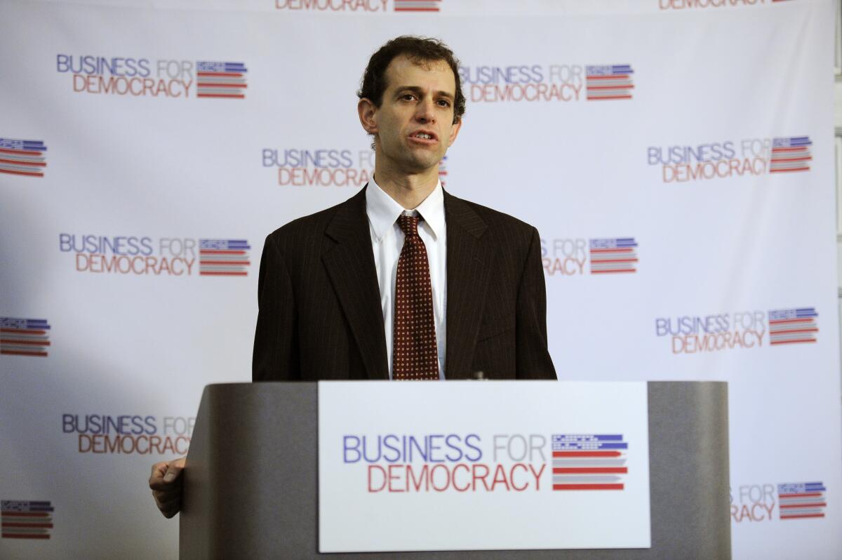 A man stands at a lectern.