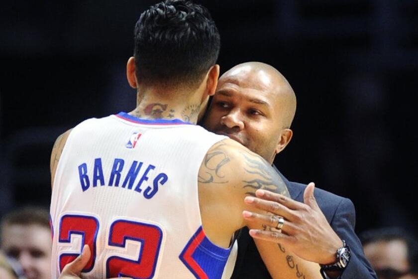Clippers forward Matt Barnes embraces Knicks Coach Derek Fisher before their game on Dec. 31, 2014.