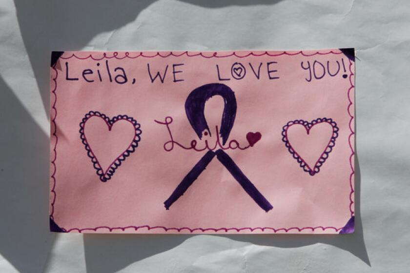 A sign remembering Leila Fowler hangs on a fence at Jenny Lind Elementary School in Valley Springs, Calif.