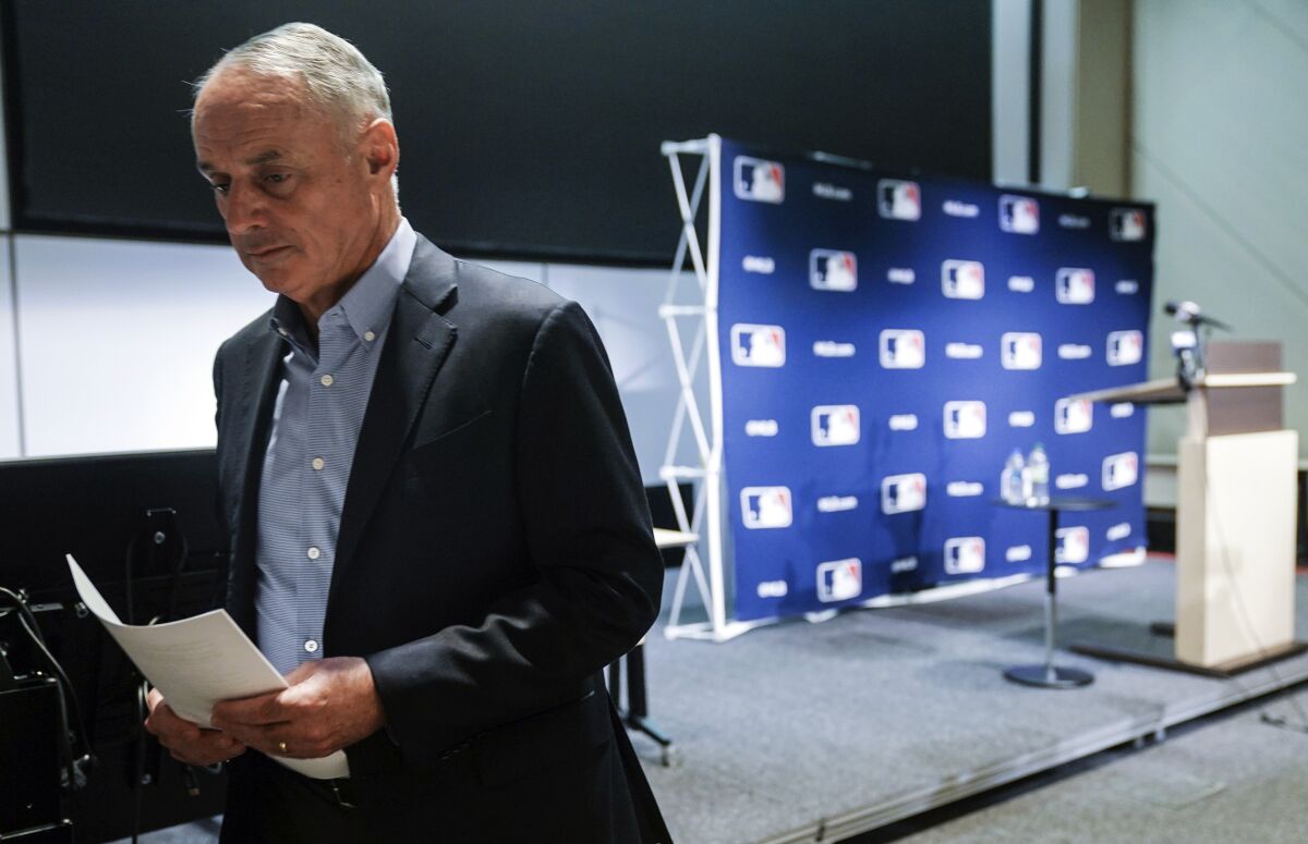 Major League Baseball commissioner Rob Manfred leaves after speaking at a news conference, Thursday March 10, 2022, in New York. Major League Baseball’s acrimonious lockout ended Thursday when a divided players’ association voted to accept management’s offer to salvage a 162-game season that will start April 7. (AP Photo/Bebeto Matthews)
