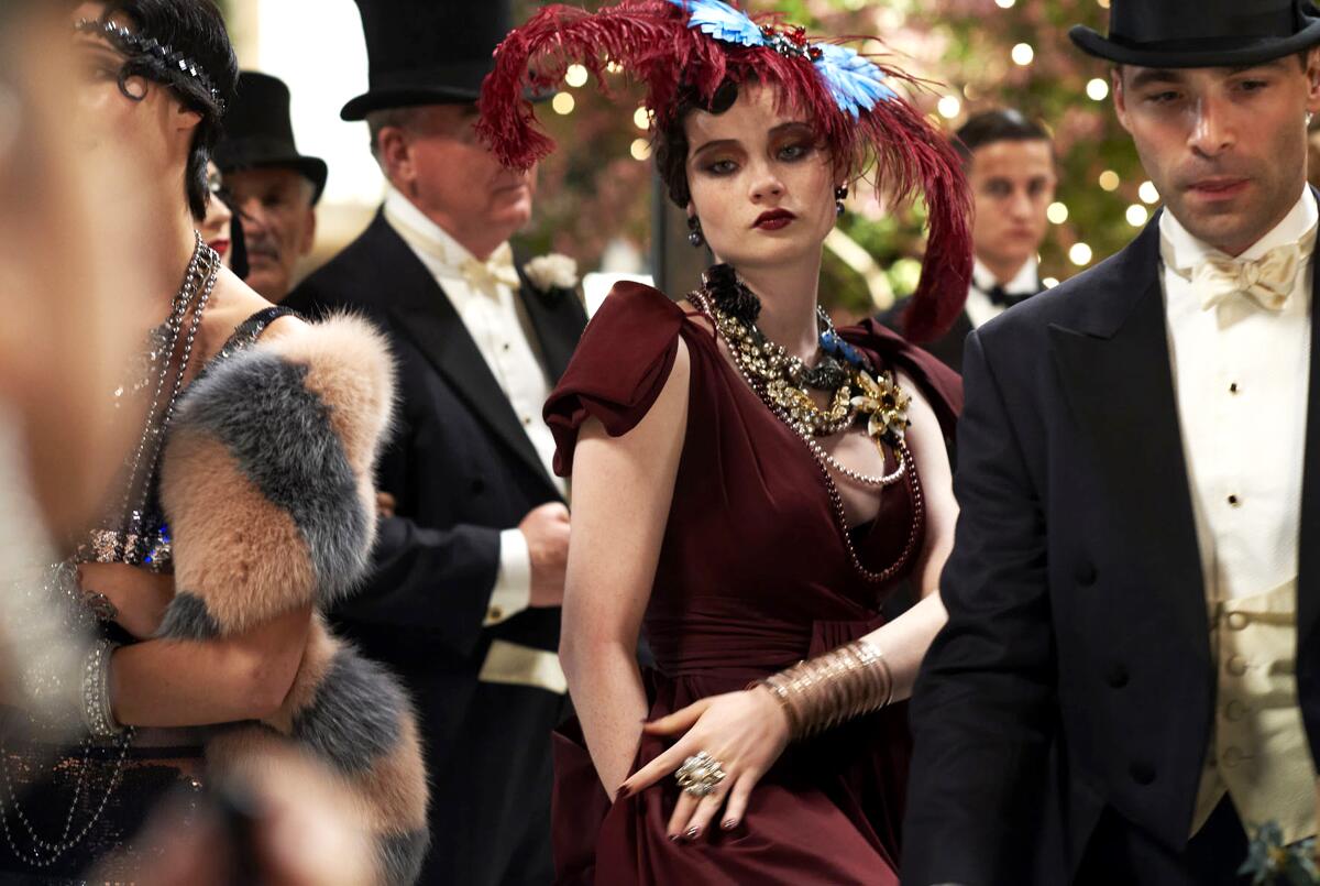 People in 1920s formal dress in a scene from Baz Luhrmann’s "The Great Gatsby."