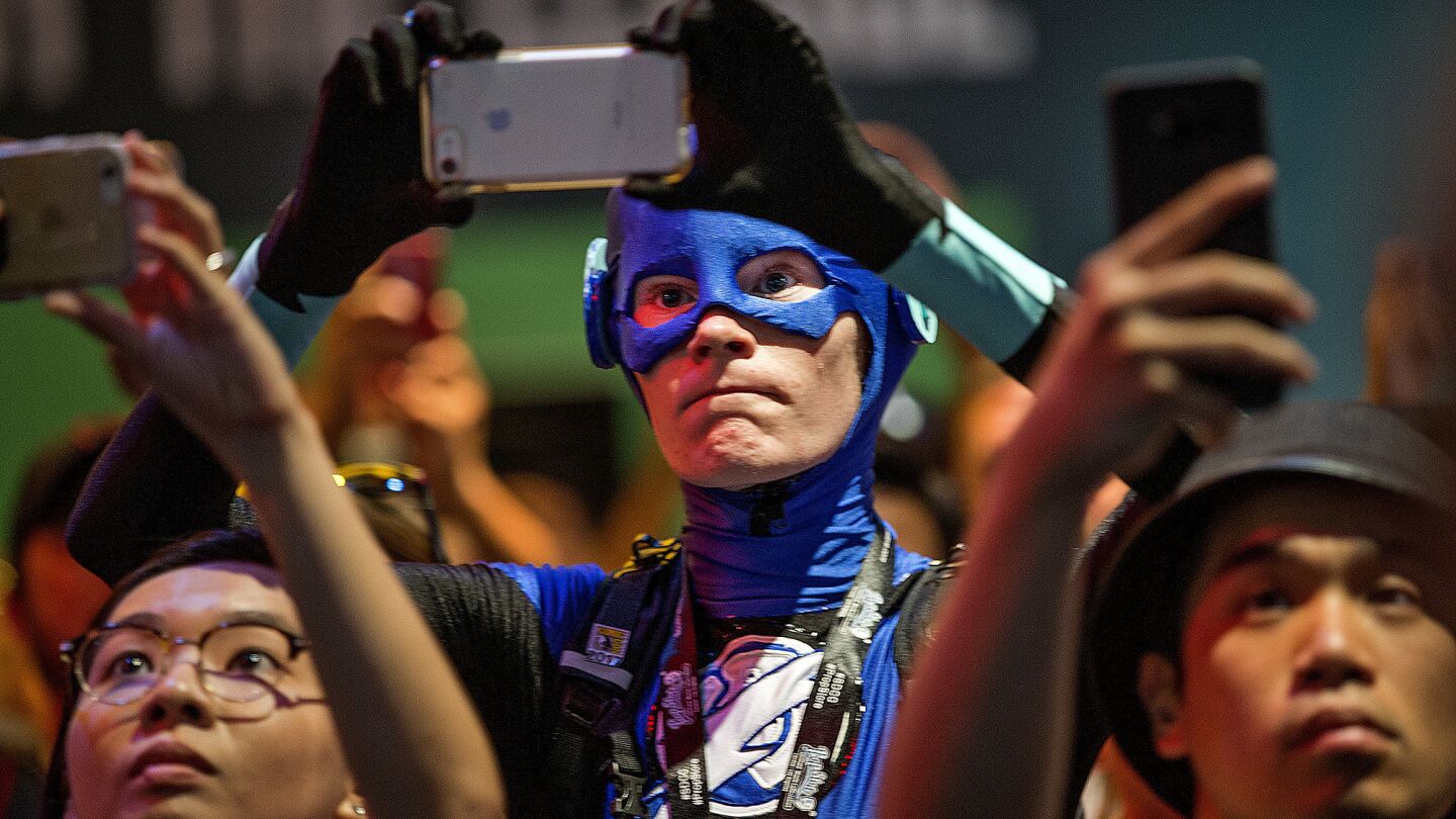 Fans crowd snap photos Saturday as the cast of "Justice League" signs autographs and meets fans at the DC Comics booth at Comic-Con 2017.