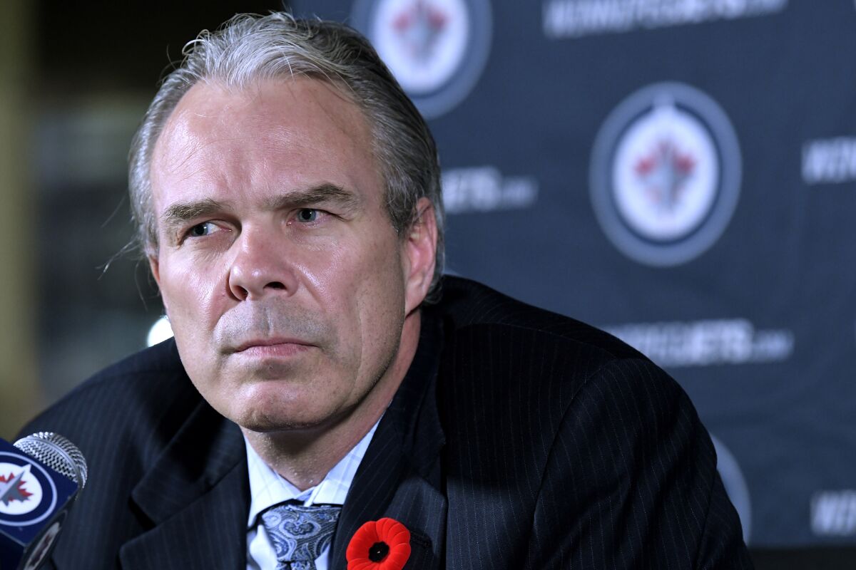 Winnipeg Jets general manager Kevin Cheveldayoff listens to reporters' questions during a news conference with Jets owner Mark Chipman, Tuesday, Nov. 2, 2021, in Winnipeg, Manitoba. The Chicago Blackhawks held settlement talks Tuesday with attorney for a former player who is suing the team after he accused an assistant coach of sexual assault in 2010 and the team largely ignored the allegations. Cheveldayoff was the Blackhawks' GM for two seasons, 2009-2011. The NHL decided not to discipline Cheveldayoff based on his limited role in Chicago’s front office at the time. (Fred Greenslade/The Canadian Press via AP)