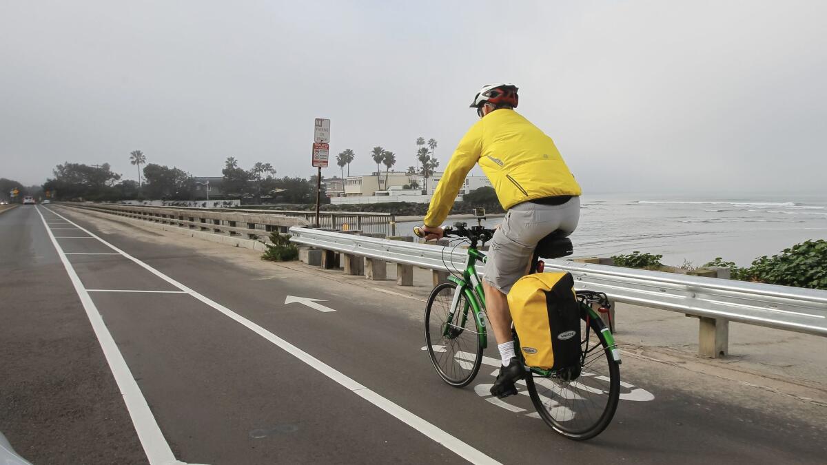 Douglas Alden commutes to work along Camino del Mar in Del Mar, Calif.