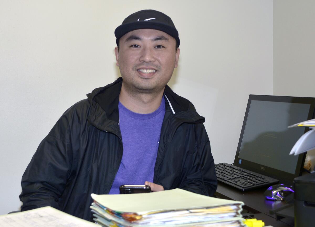 Case manager Lewis Kim is making sure the families the nonprofit is currently serving are receiving wellness checks over the phone on a daily basis.