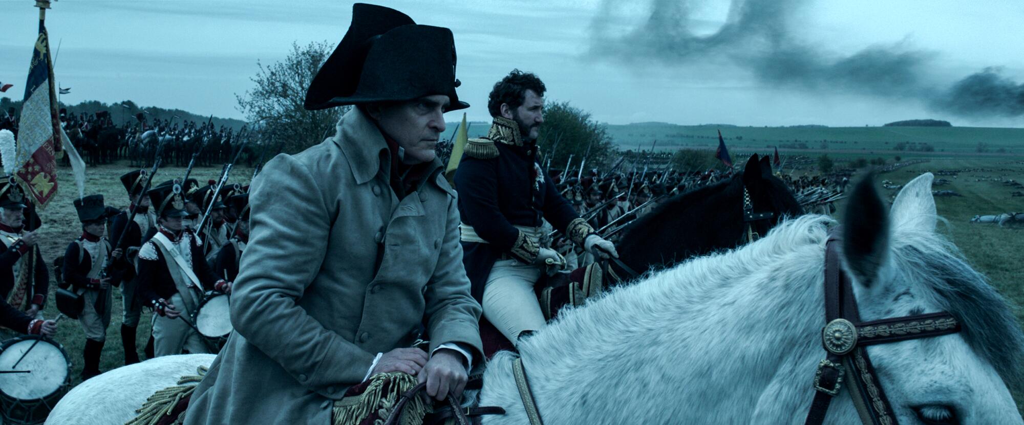 A man sits on a horse, scanning the battlefield.
