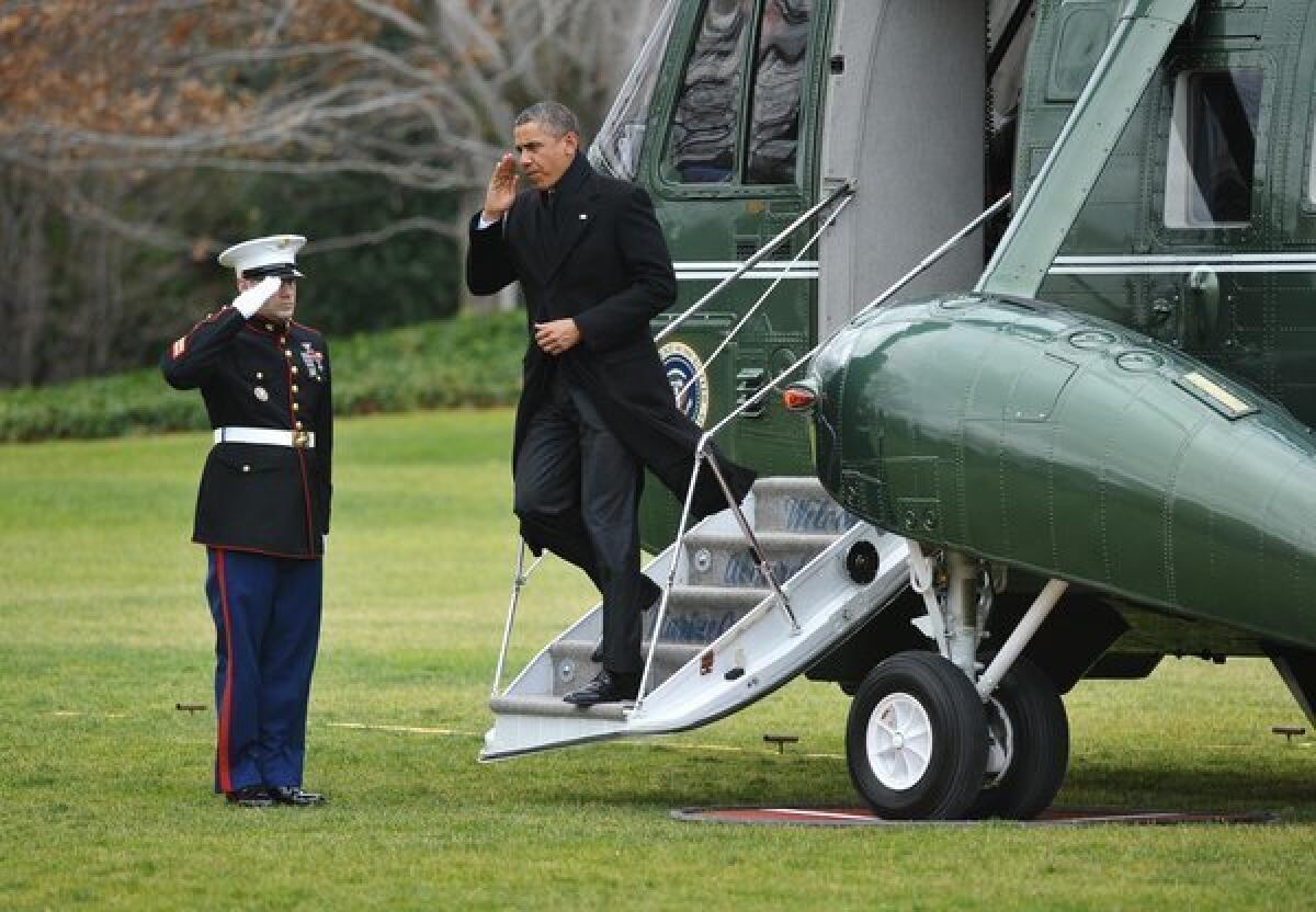 President Obama steps off Marine One upon returning to the White House on Thursday. Obama returned to Washington under pressure to forge a deal with Republicans to avoid the tax hikes and spending cuts of the "fiscal cliff."