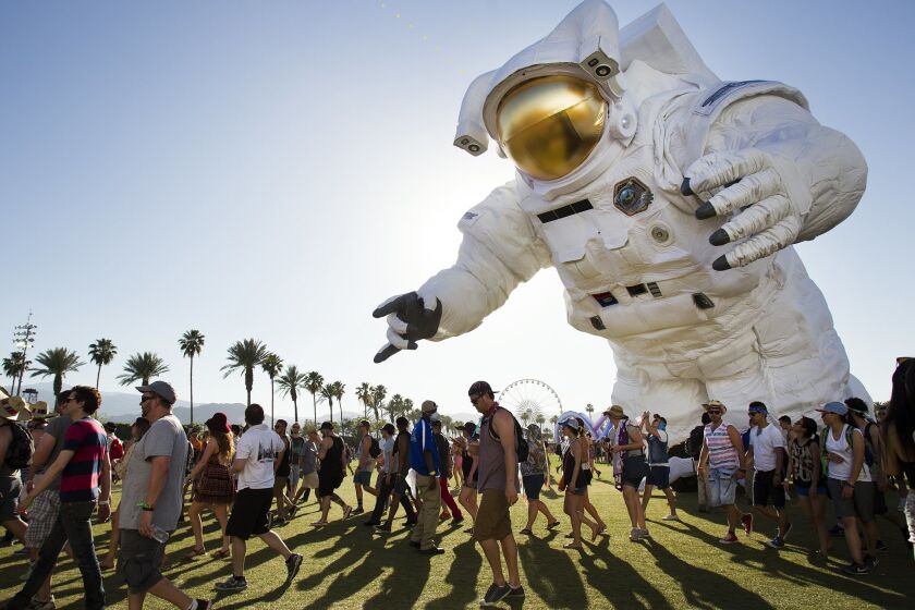 On the first day of the Coachella Valley Music and Arts Festival a sold out crowd got the party started. The moving art piece called Escape Velocity by Poetic Kinetics moves past the crowd.