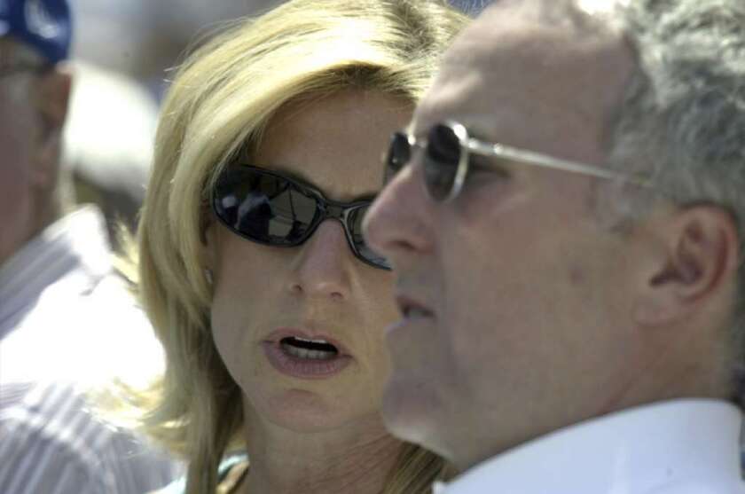 Former Dodgers owners Frank and Jamie McCourt watch a game at Dodger Stadium in April 2005.