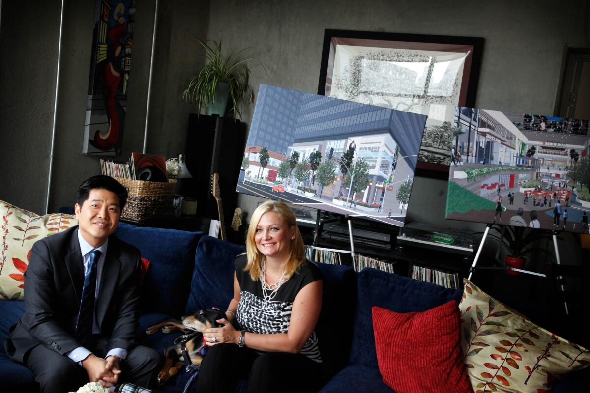 Architect Simon Ha and his wife, Nikki Olson-Ha, appear during a news conference in their loft apartment in downtown Los Angeles. They released a survey showing that more people, with more money, are moving into downtown.