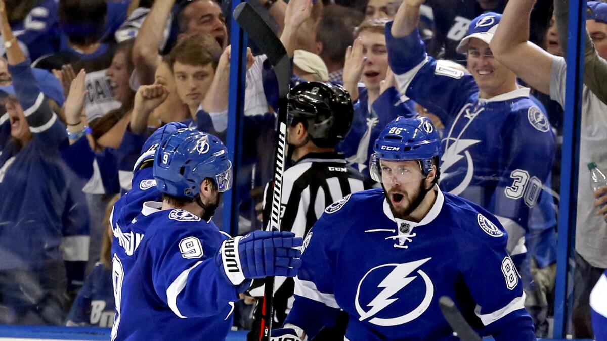 Tampa Bay's Nikita Kucherov, right, celebrates his goal against the Islanders with teammate Tyler Johnson (9) during the third period Sunday.