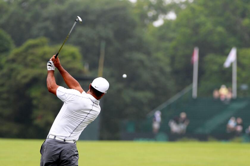 Tiger Woods hits a shot during a practice round at Merion Golf Club.