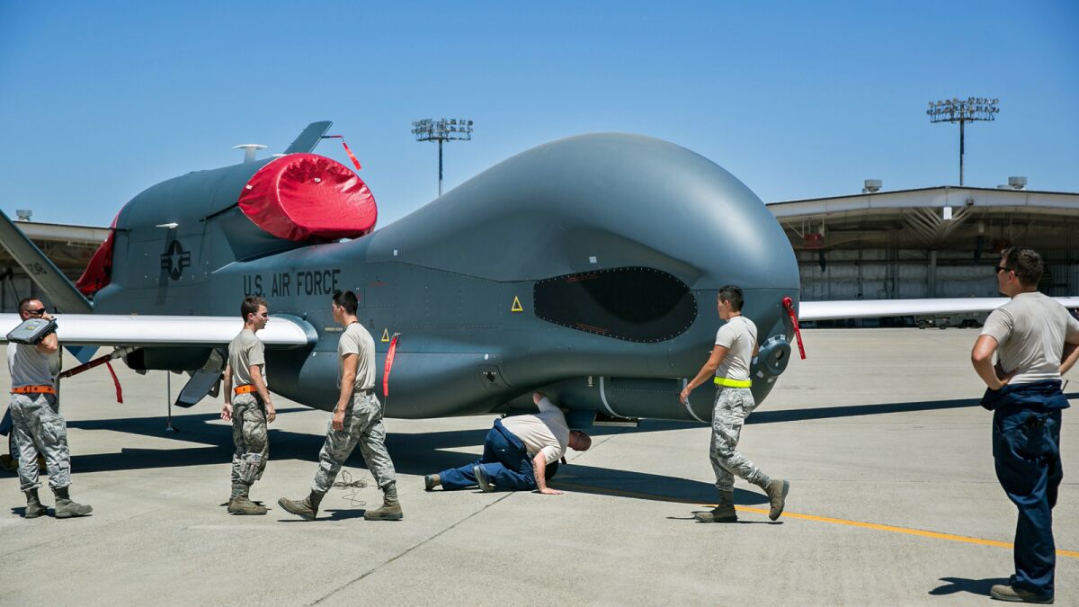 Crews tow an RQ-4 Global Hawk at Beale Air Force Base in California in June 2015.