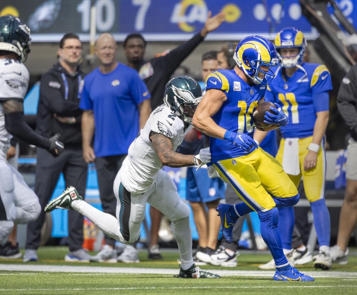 Rams receiver Cooper Kupp runs past Eagles cornerback Darius Slay after making a catch.