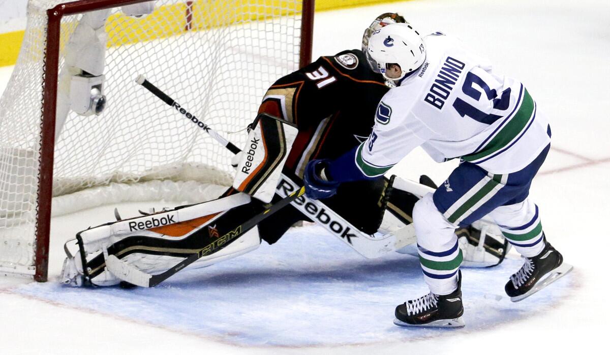 Canucks center Nick Bonino scores the game-winning goal by sliding the puck under the right pad of Ducks goalie Frederik Andersen during a shootout Sunday night at the Honda Center.
