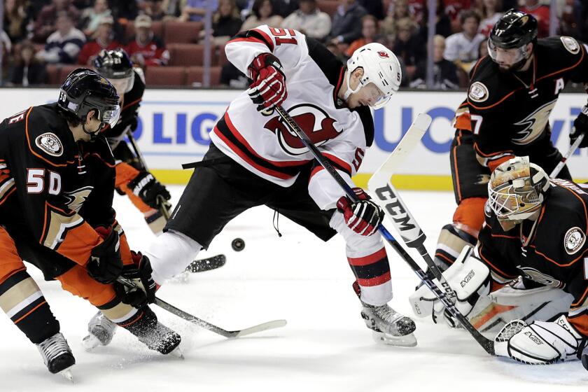 Ducks center Antoine Vermette (50) clears the puck as the Devils' Sergey Kalinin looked to score in the third period Thursday.