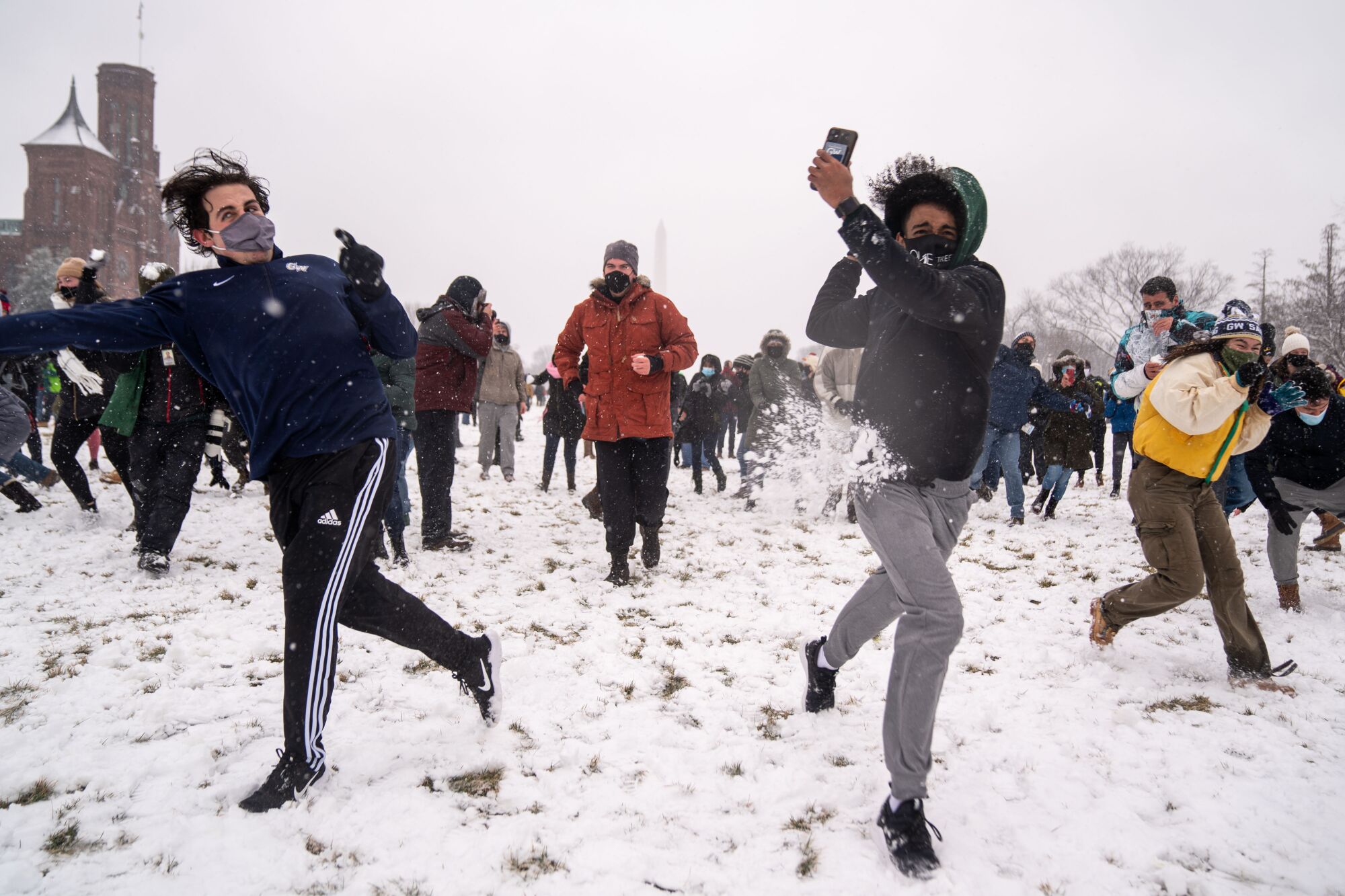 People take part in a snowball fight 