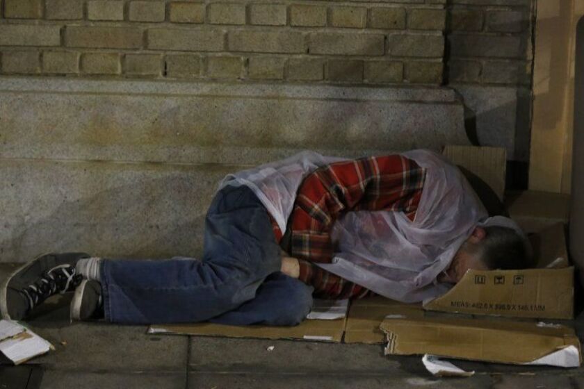 San Diego, California, USA, January 26th 2018. | Homeless man sleeping on the sidewalk in downtown. | Alejandro Tamayo © The San Diego Union Tribune 2018