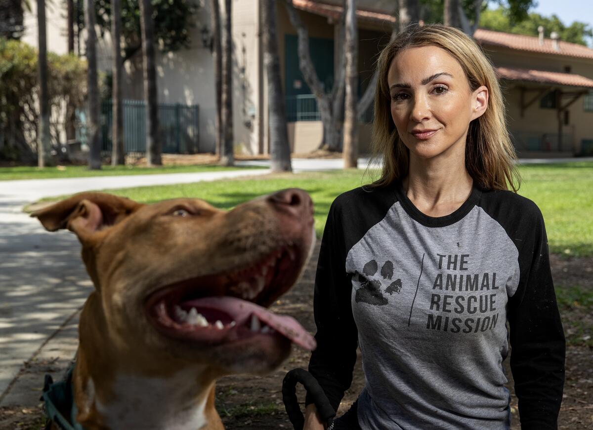 A woman and a dog at a park