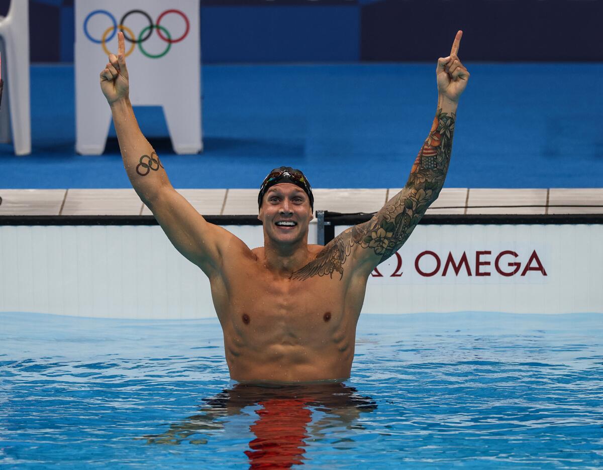 Caeleb Dressel celebrates after winning gold in the men's 100-meter freestyle at the Tokyo Olympics.
