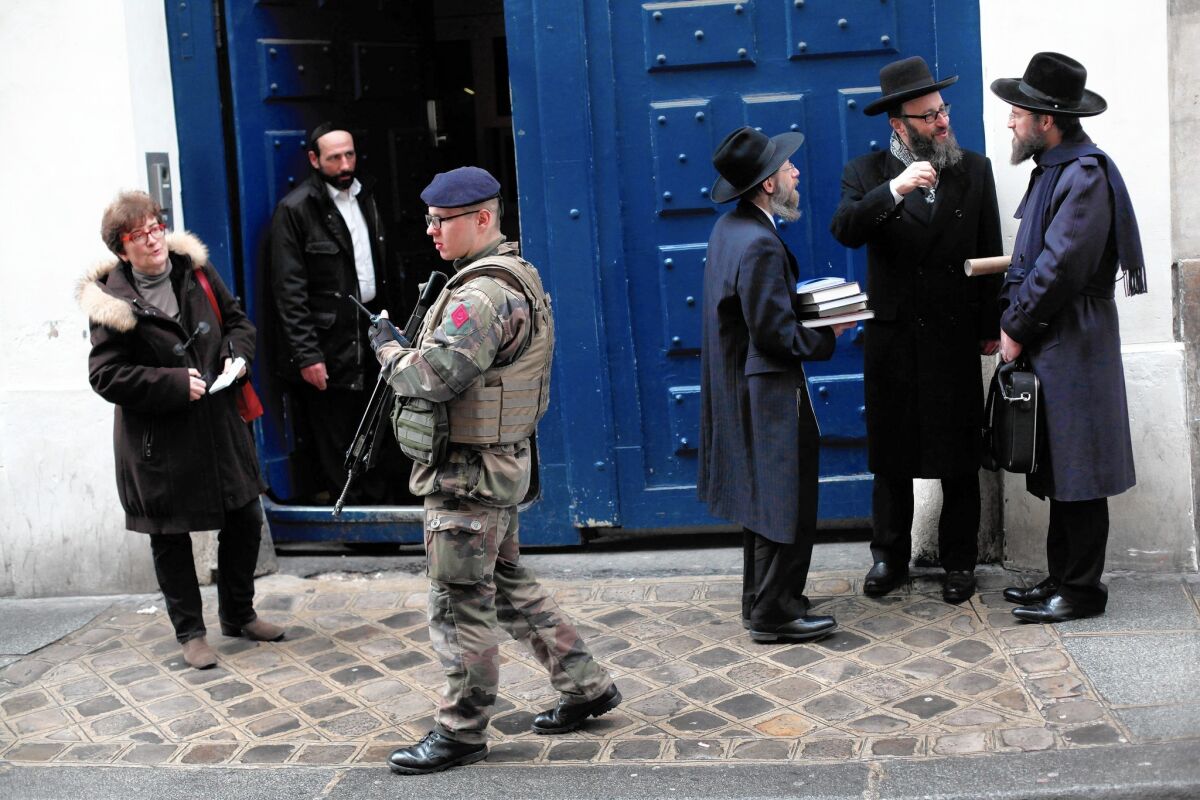 A French soldier patrols next to a Jewish school in Paris.