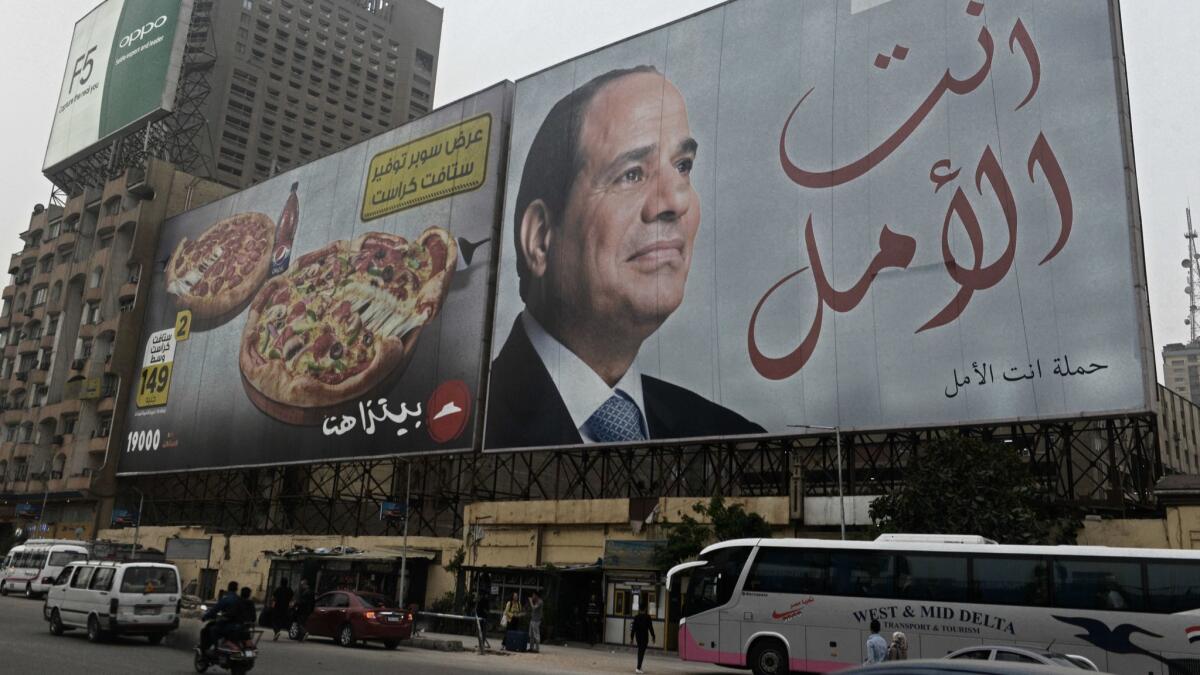 An election billboard for Egyptian President Abdel Fattah Sisi looms over downtown Cairo.