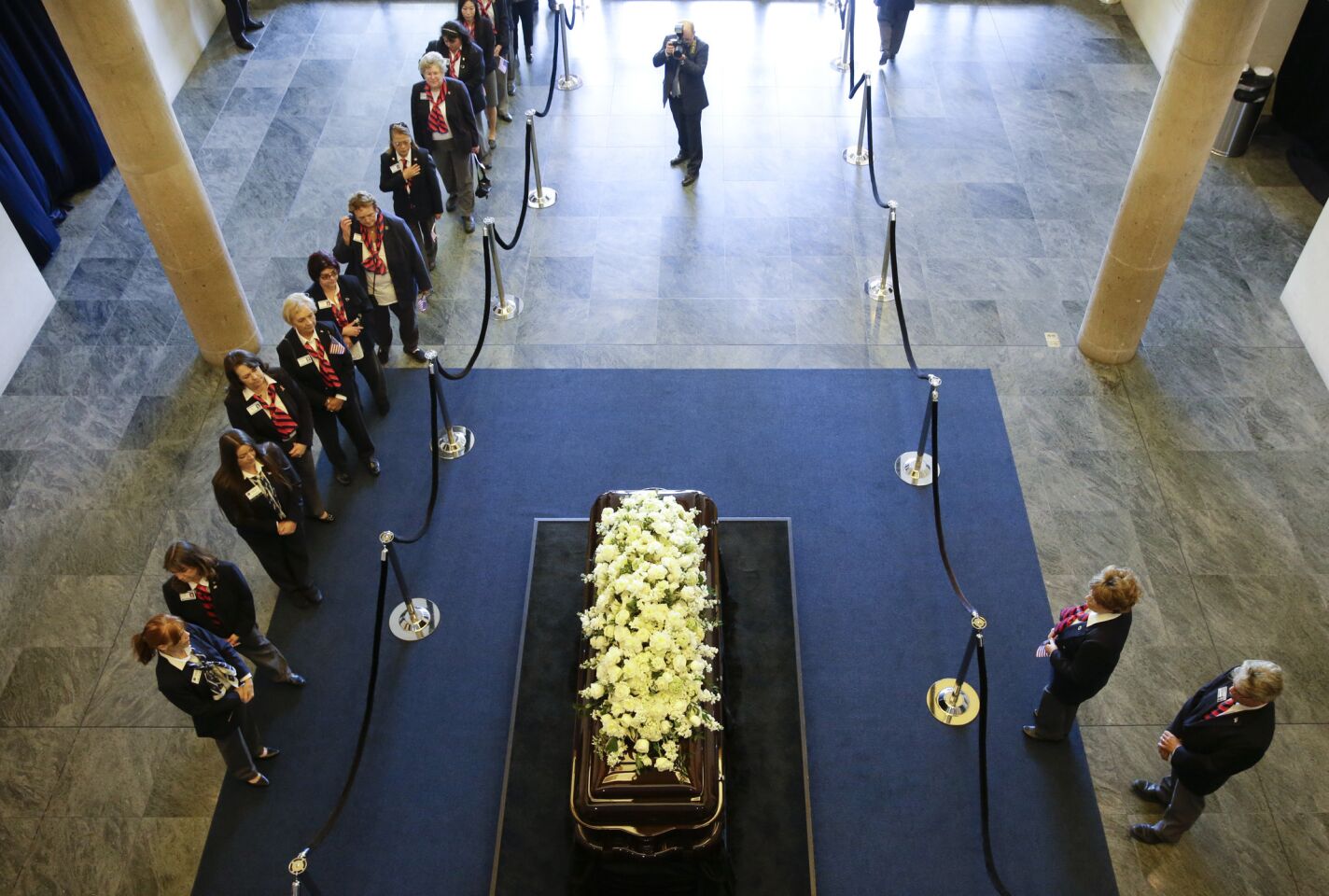 Library volunteers pause as they pay their respects beside the casket of Nancy Reagan at the Ronald Reagan Presidential Library in Simi Valley.