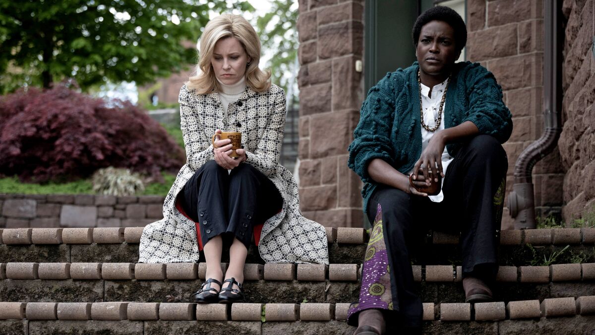 Two women sit on steps, looking pensive, in the movie "Call Jane."