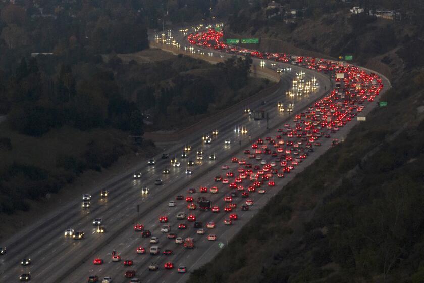 LOS ANGELES, CA - November 23, 2022 - Brake lights shine red as northbound 405 traffic backs up in the Sepulveda Pass on Wednesday, Nov. 23, 2022 in Encino, CA. AAA predicts that 54.6 million people will travel at least 50 miles from home in the U.S. this week, a 1.5% bump over Thanksgiving last year and only 2% less than in 2019. The auto club and insurance seller says nearly 49 million of those will travel by car, and 4.5 million will fly between Wednesday and Sunday. (Brian van der Brug / Los Angeles Times)