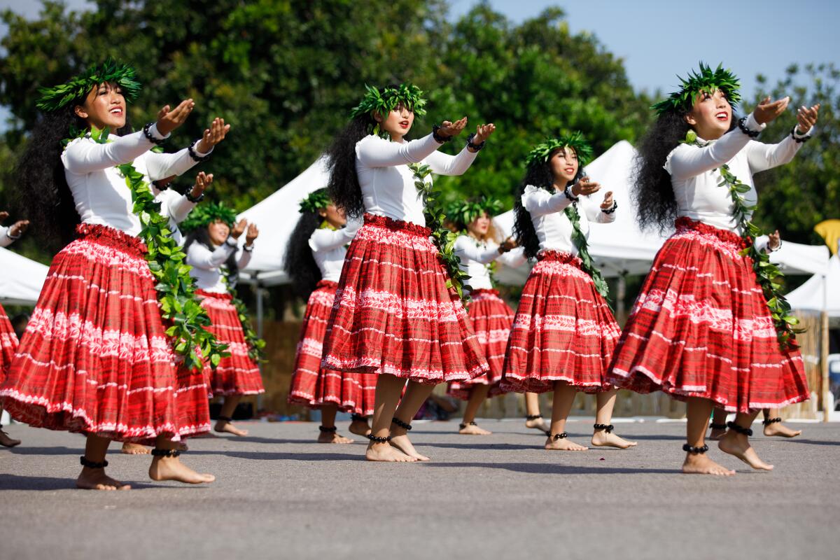 Members of Na Pua “Ilima, a Polynesian dance group, perform onstage during the annual Pacific Islander Festival