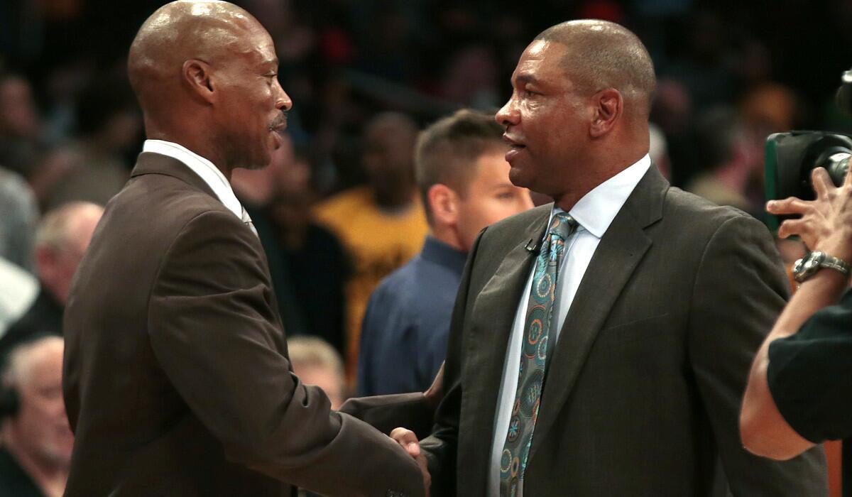 Coaches Byron Scott, left, of the Lakers and Doc Rivers of the Clippers greet each other before the start of their game Friday night at Staples Center.