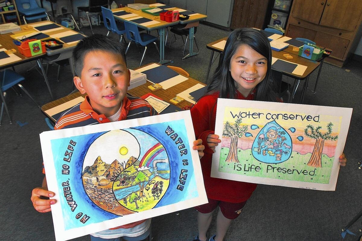 Classmates Derek Jiang, 10, and Shelby Perez, 11, of La Cañada Elementary School, are 1st and 2nd place winners of the "Water is Life" art contest, sponsored by Foothill Municipal Water District on Monday, May 5, 2014. The two are coincident winners of 105 entrants from Altadena to La Crescenta, in all grades from Kindergarten to 12th grade. For first place, Jiang won $150, and for 2nd place, Perez won $100.