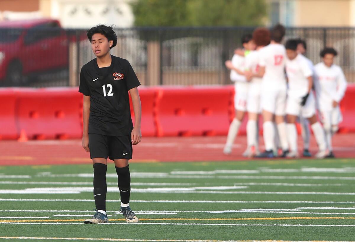 Los Amigos' Eduardo Reyes can't bear to watch as Redlands East Valley celebrates a go-ahead goal 
Wednesday.