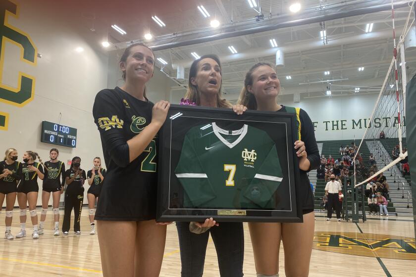 Former Mira Costa, UCLA and beach volleyball standout Holly McPeak receives a framed high school jersey.
