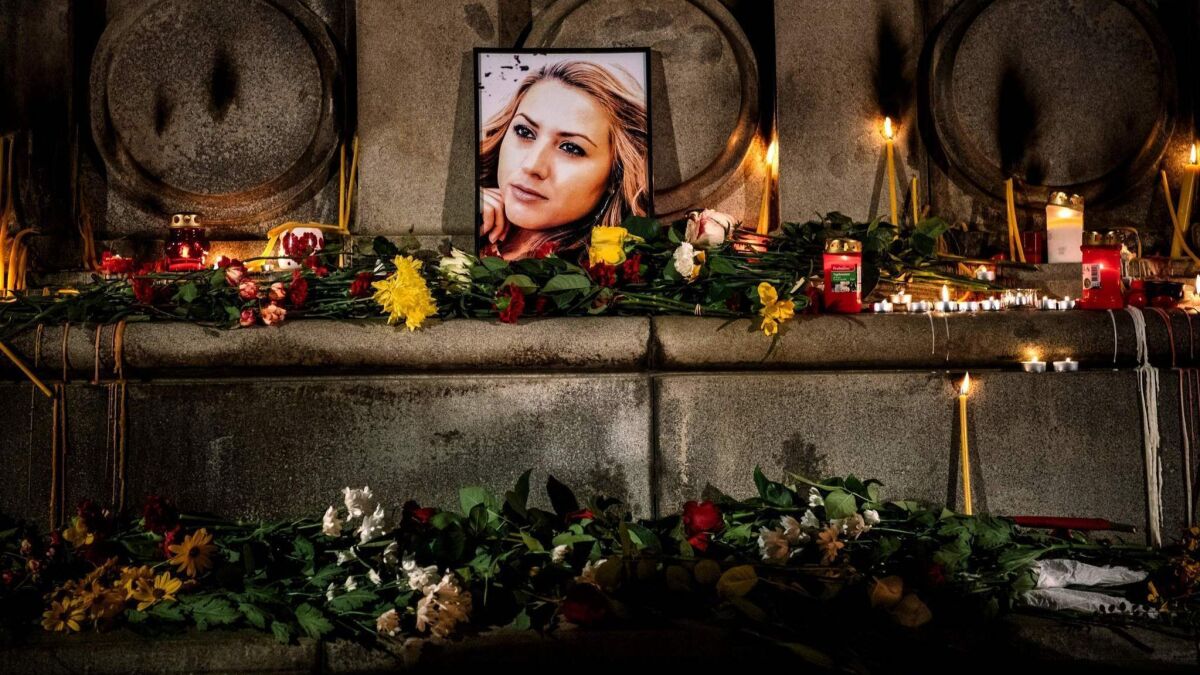This picture taken on Monday shows a portrait of slain Bulgarian television journalist Viktoria Marinova during a candlelight vigil in the city of Ruse.