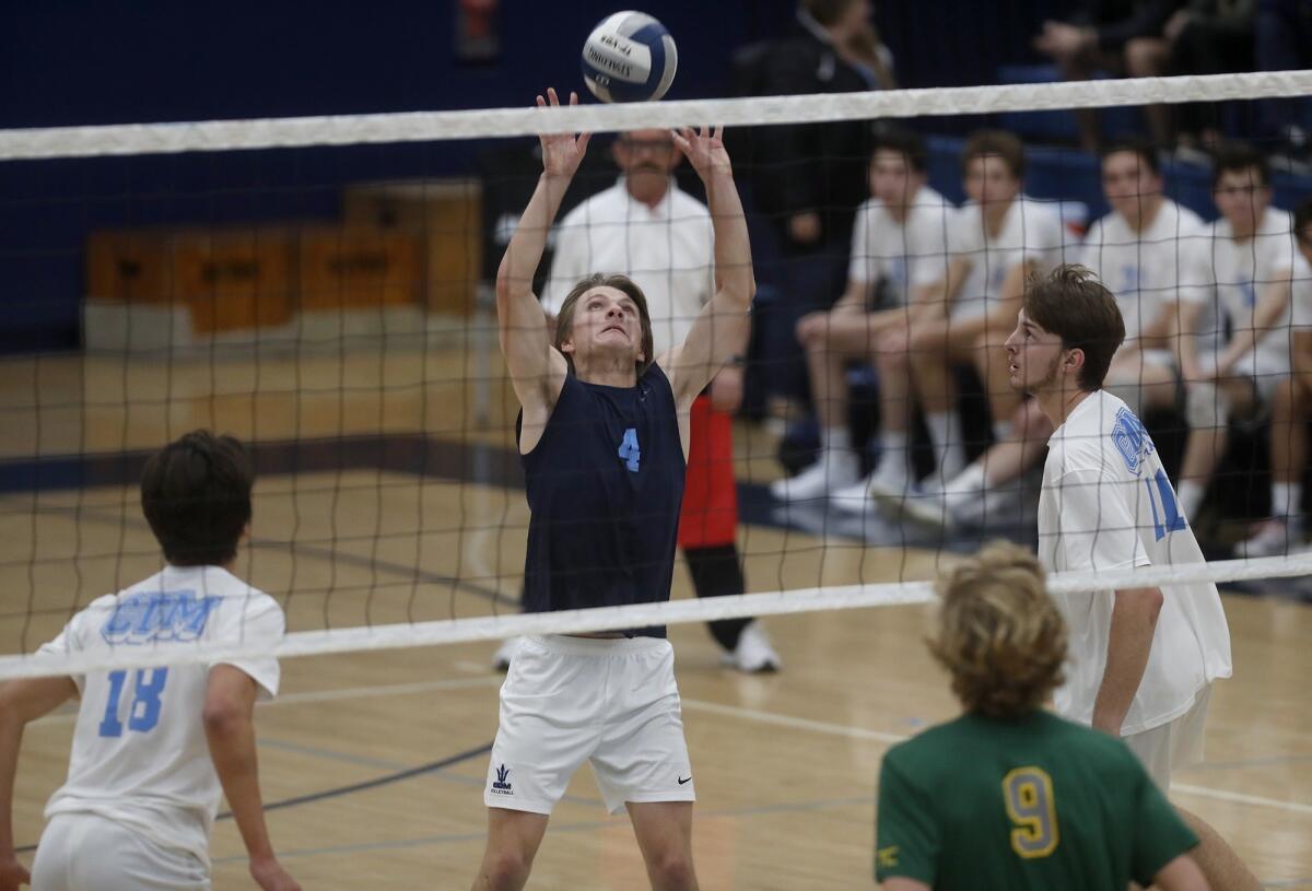 Corona del Mar High's Connor Zylstra (4) sets the ball against Manhattan Beach Mira Costa during the first set of a nonleague match on Tuesday