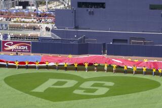 A large U.S. flag is unfurled for Padres opening ceremony.